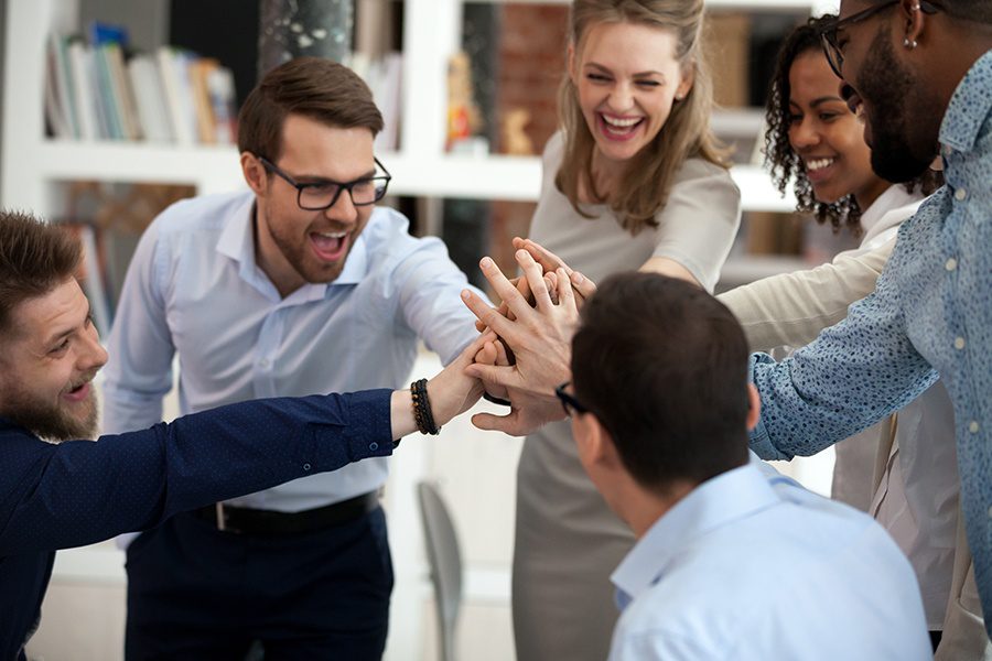 About Our Agency - Excited Motivated Business Team Giving Each Other High Five in the Office