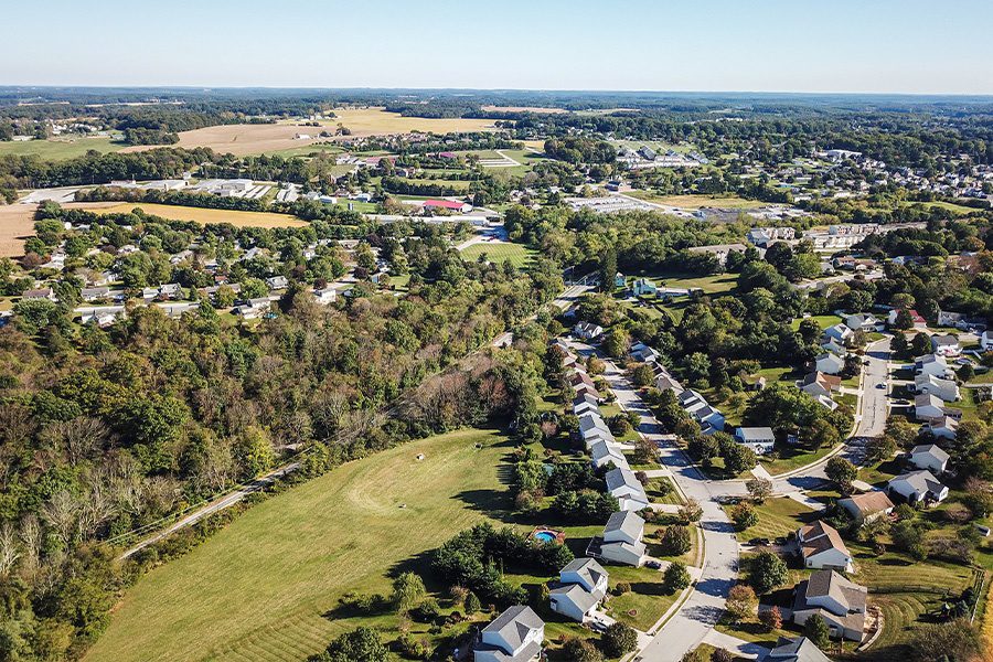 Contact - Aerial of Town and Surrounding Farmland in Northern Pennsylvania During Fall